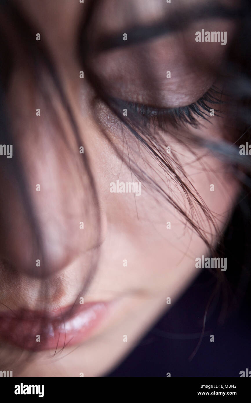 Portrait, dreamy beautiful woman with eyes closed, lock of hair in