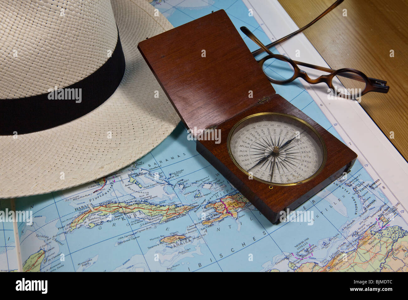 Planning a trip to the Caribbean, Cuba, historical compass and reading glasses Stock Photo
