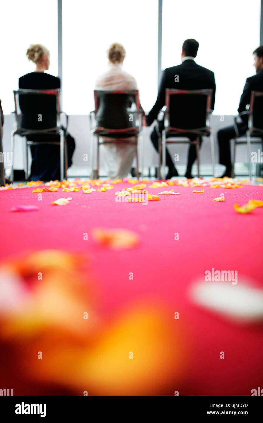 Civil wedding, bride and groom, flower petals strewn across the floor Stock Photo