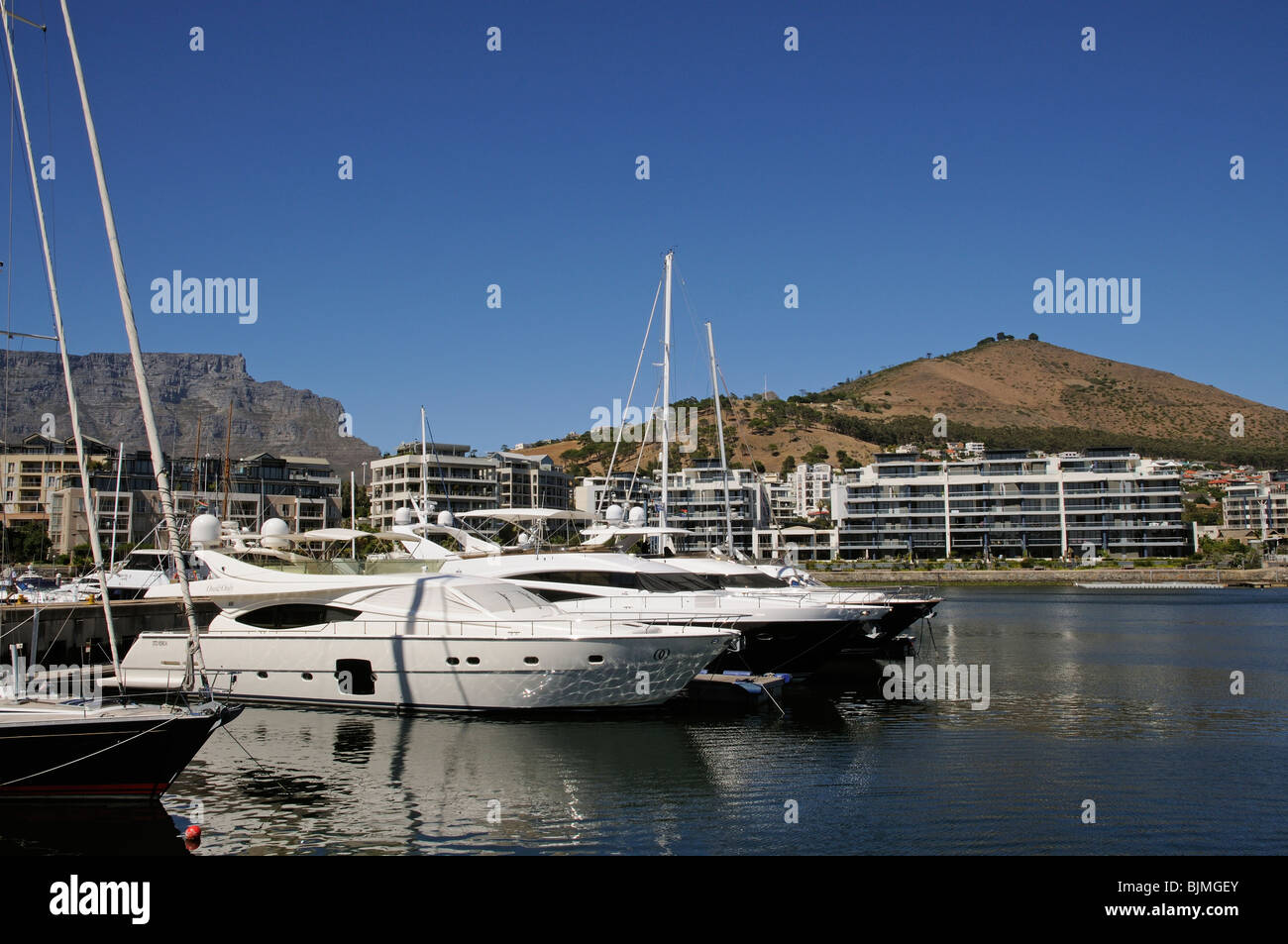 Luxury waterfront properties and moorings overlooked by Table Mountain & Signal Hill Cape Town South Africa Stock Photo