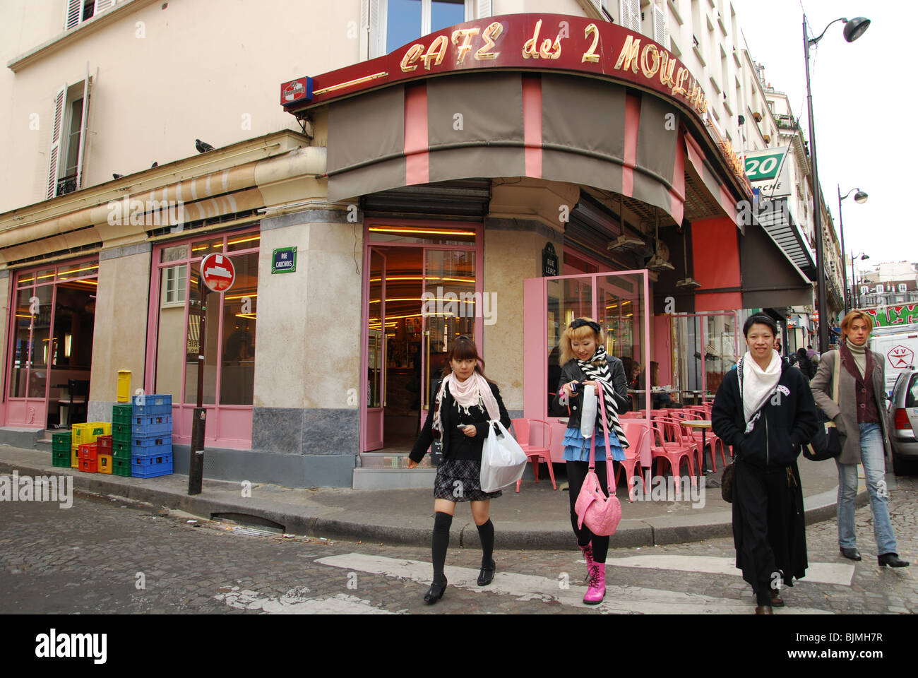 Japanese tourists at Cafe des 2 Moulins famous for Amelie film Paris France Stock Photo