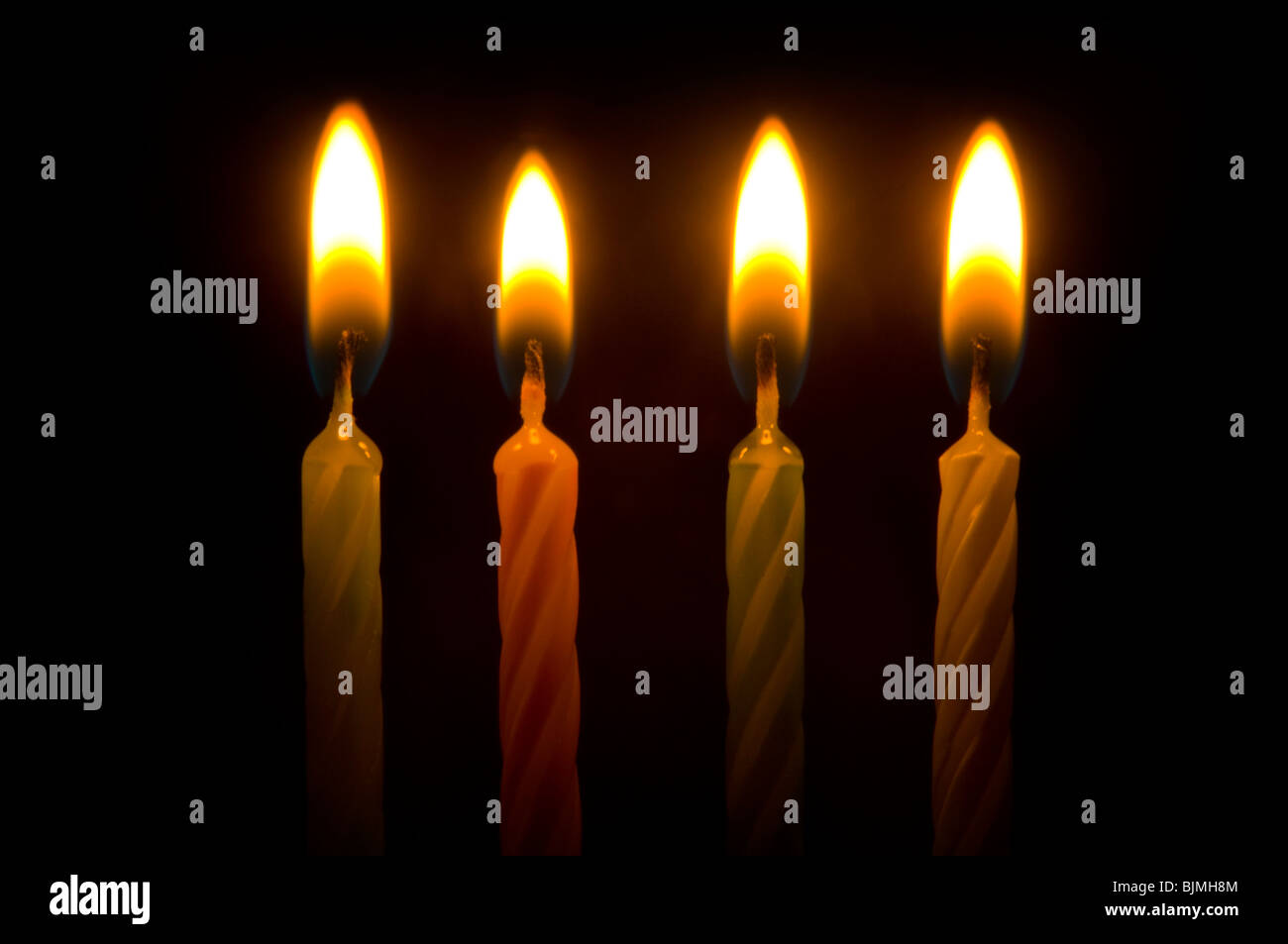 birthday candles lit with flame Stock Photo Alamy