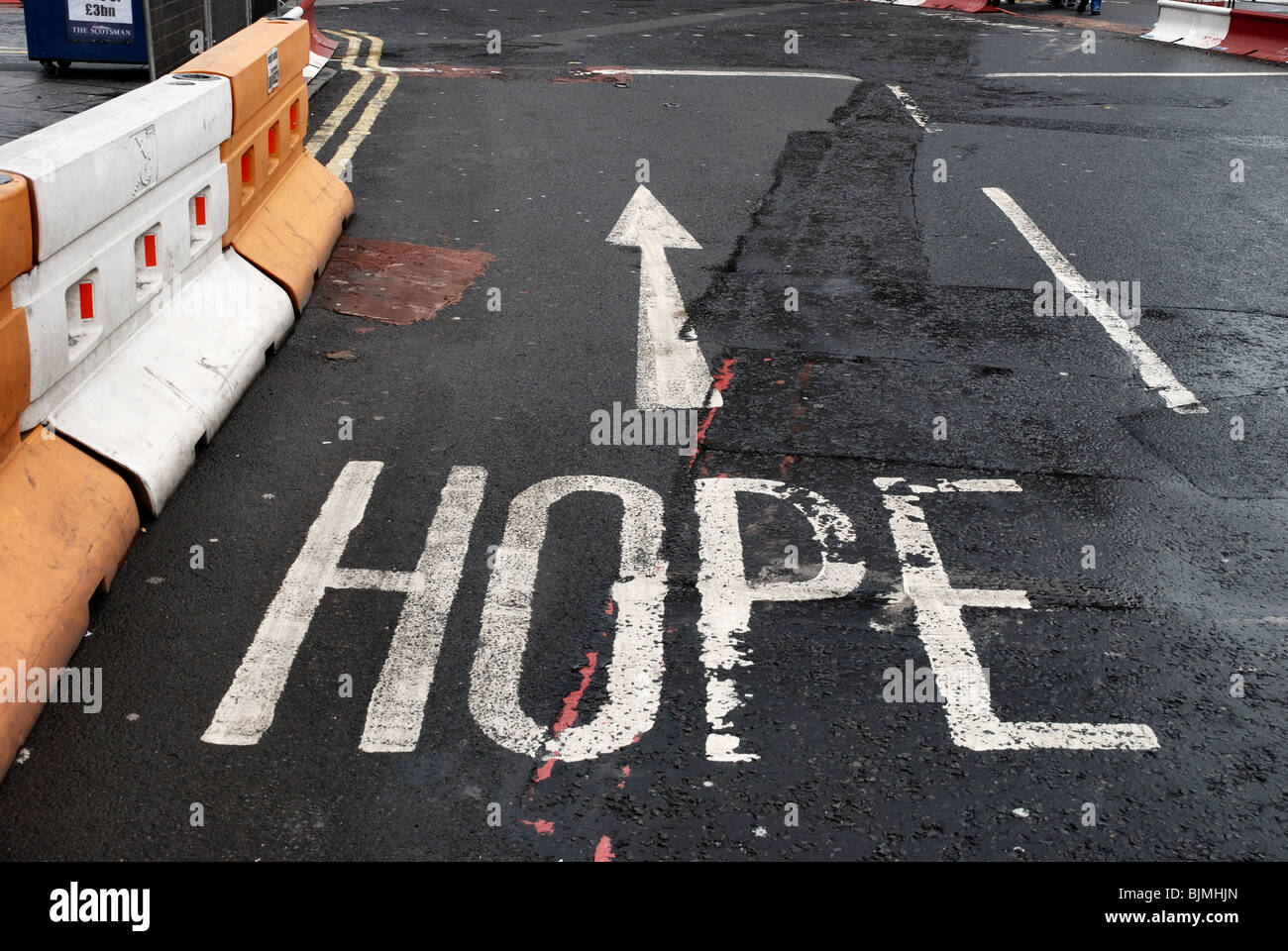 Road marking with the word 'hope' at the West End of Princes Street, Edinburgh. Stock Photo