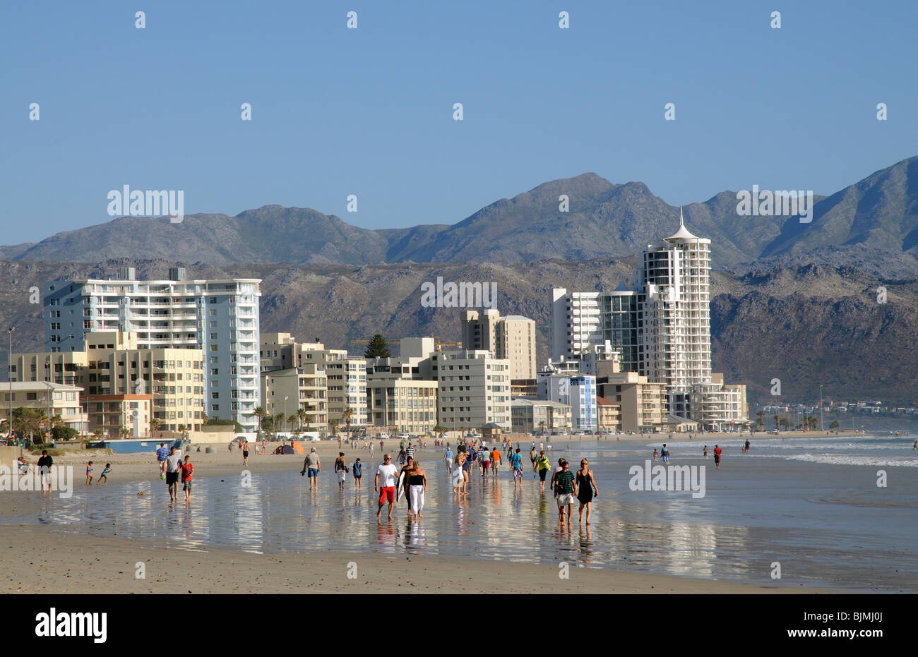Holidaymakers walking on the beach in the seaside resort called Strand