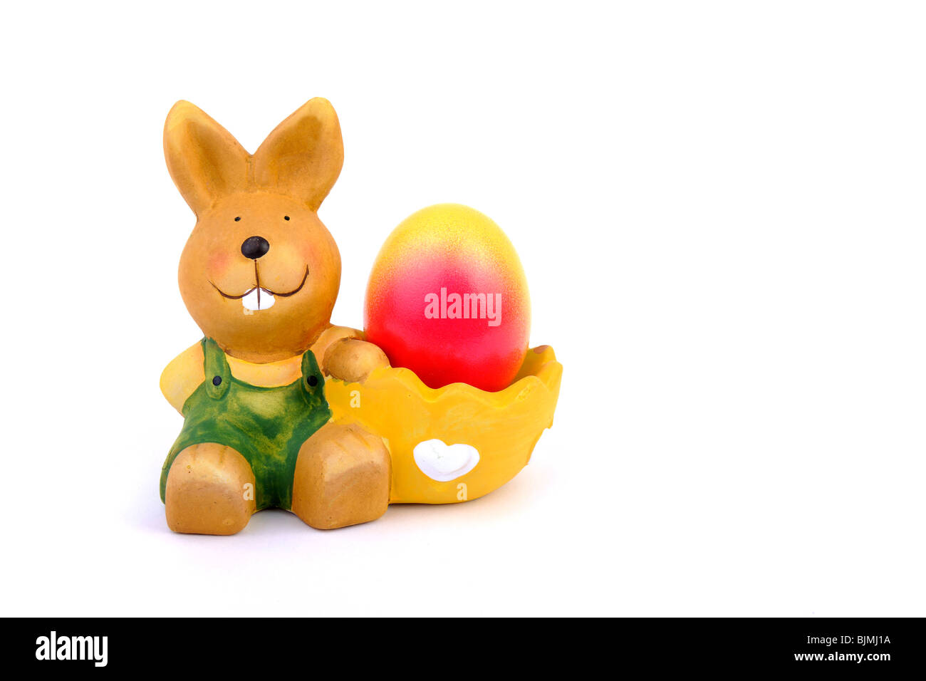 Egg cup with Easter bunny with colorful, dyed easter egg Stock Photo