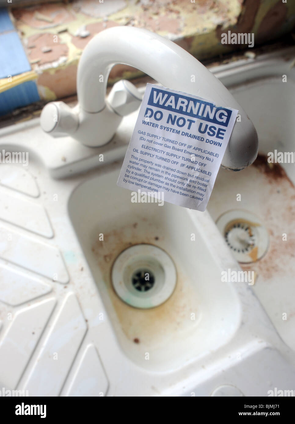 DOMESTIC HOUSEHOLD TAP AND SINK UNIT  WITH 'WARNING DO NOT USE' STICKER ON IT Stock Photo