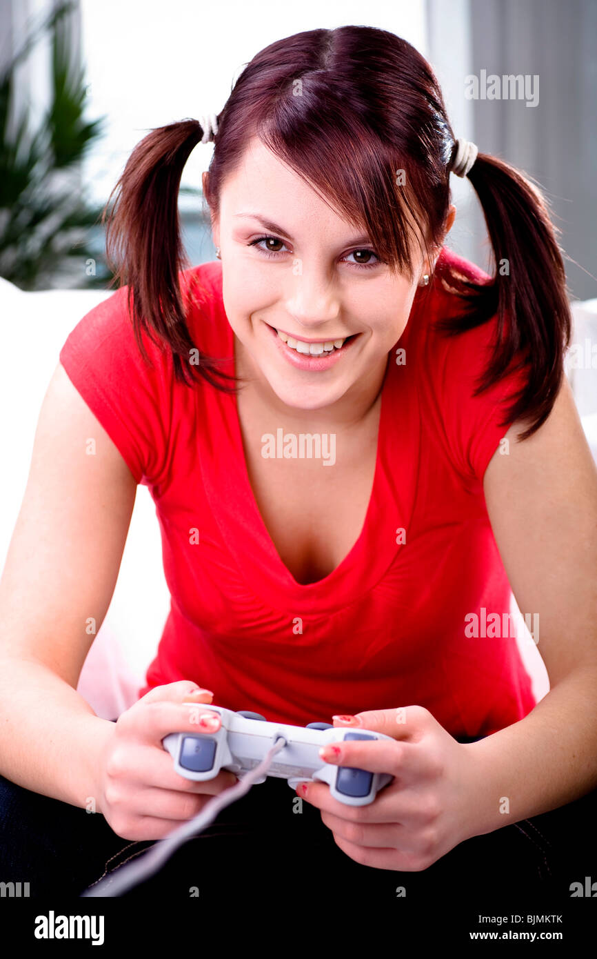 19-year-old girl playing on a game console Stock Photo