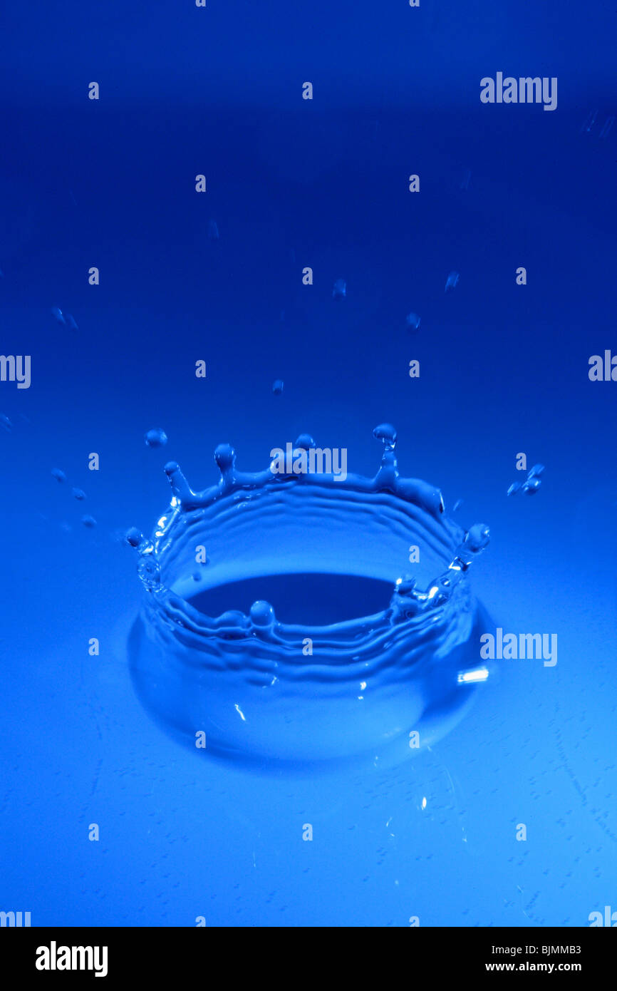 Water drop hitting a water surface Stock Photo