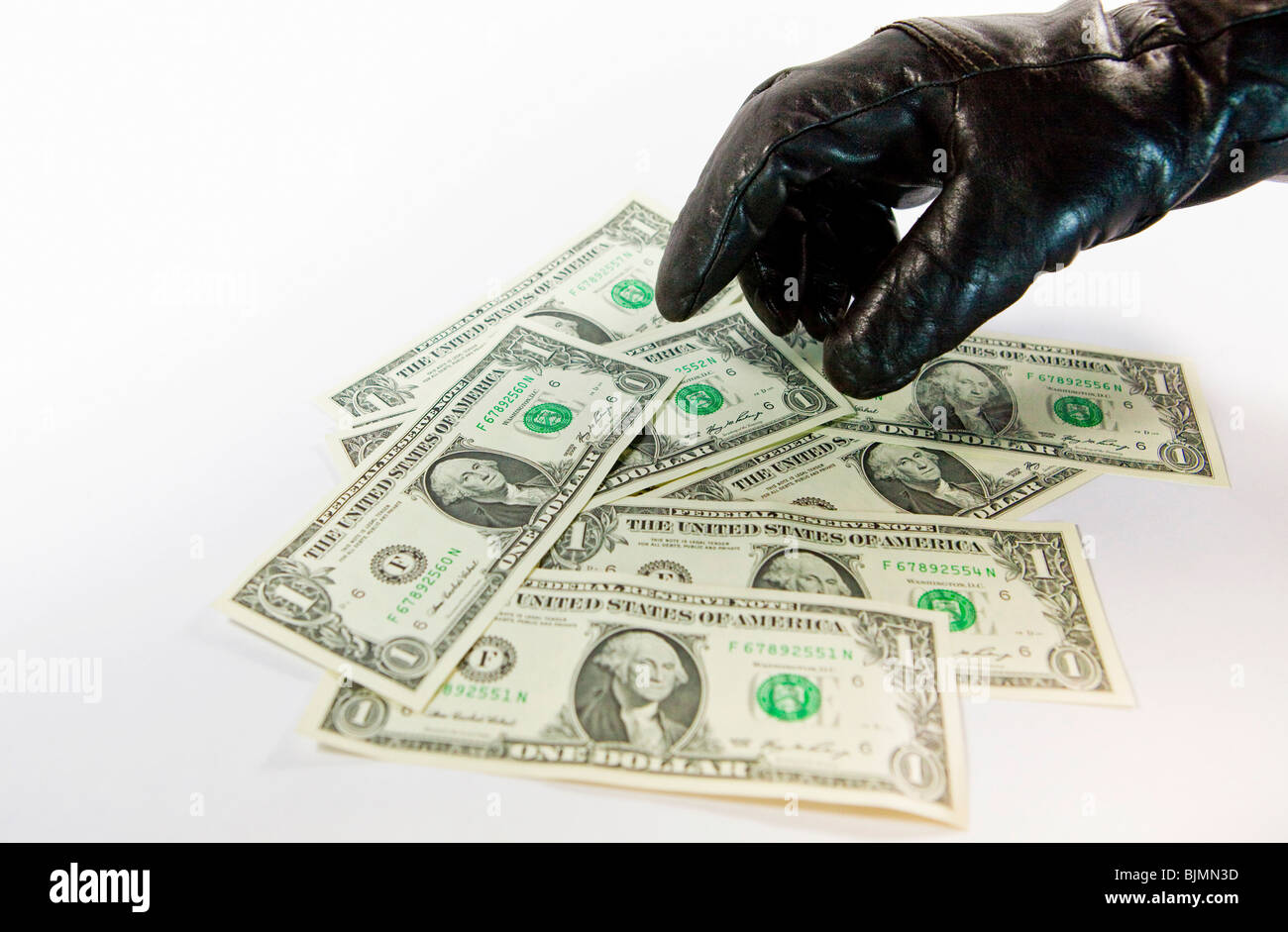 Gloved thief stealing U.S. Dollars Stock Photo