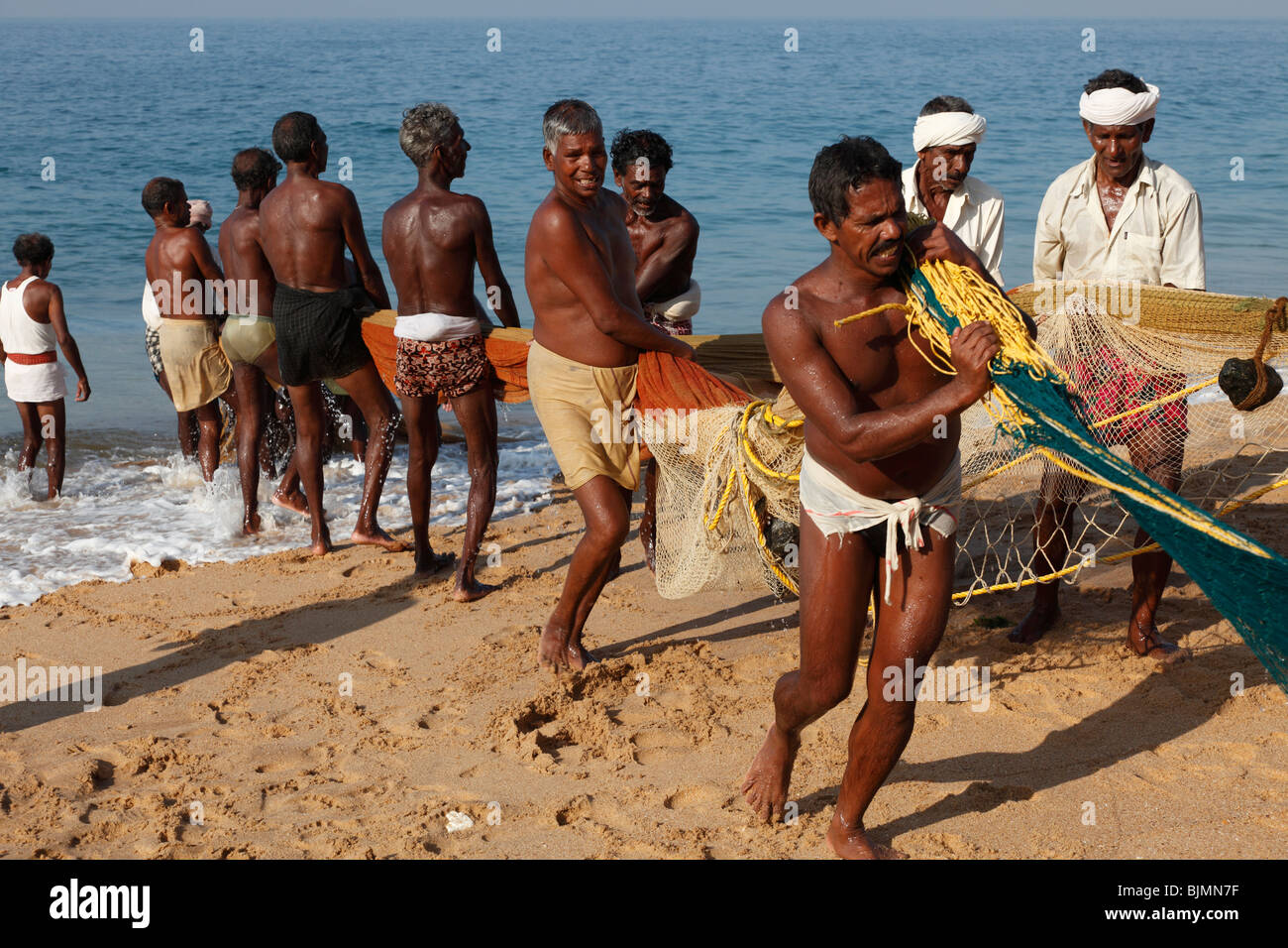 Fishermen pulling in a net, beach south of Kovalam, Malabar Coast, Malabar, Kerala, southern India, India, Asia Stock Photo