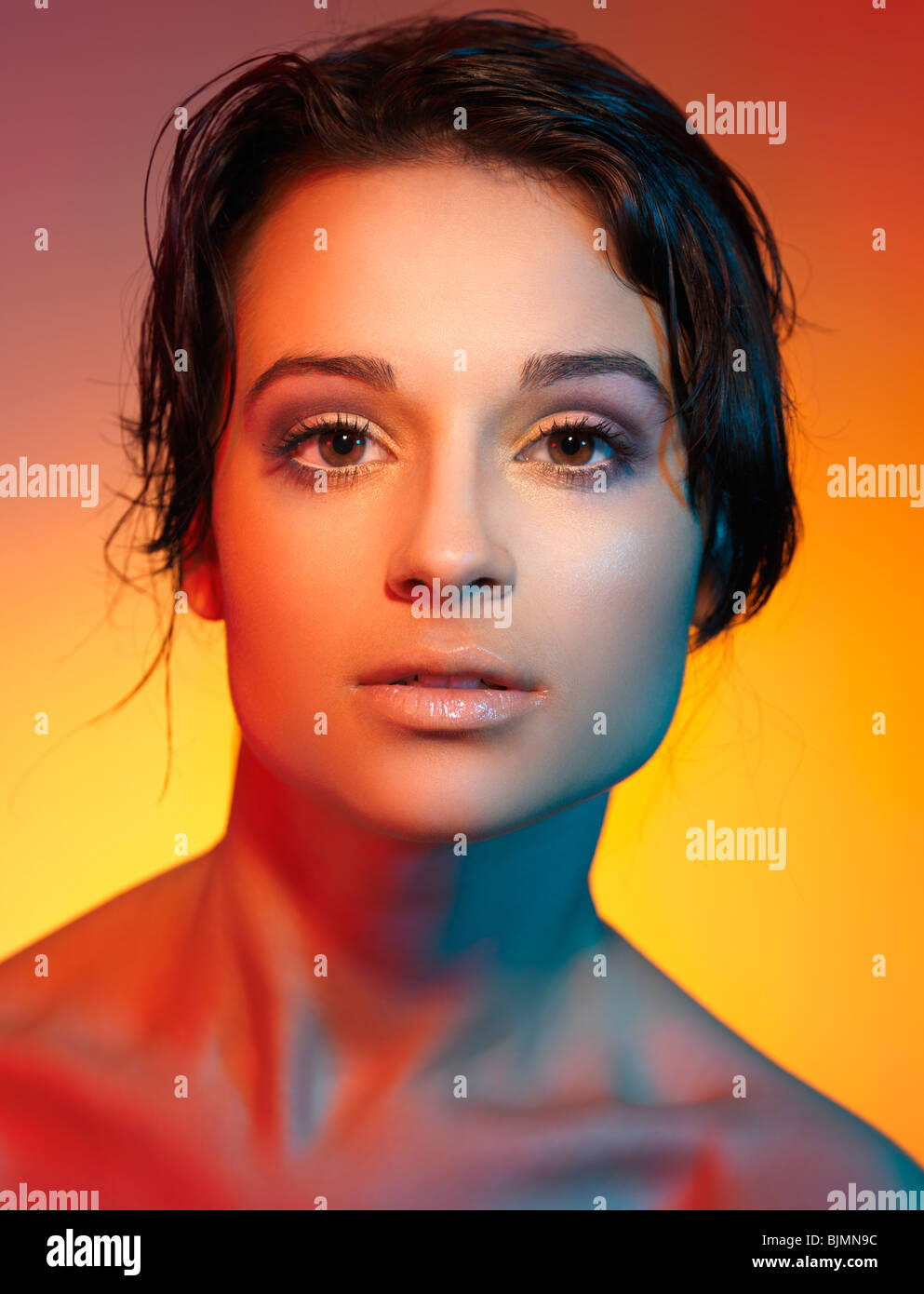 Beautiful young woman face lit with colorful lights Stock Photo - Alamy