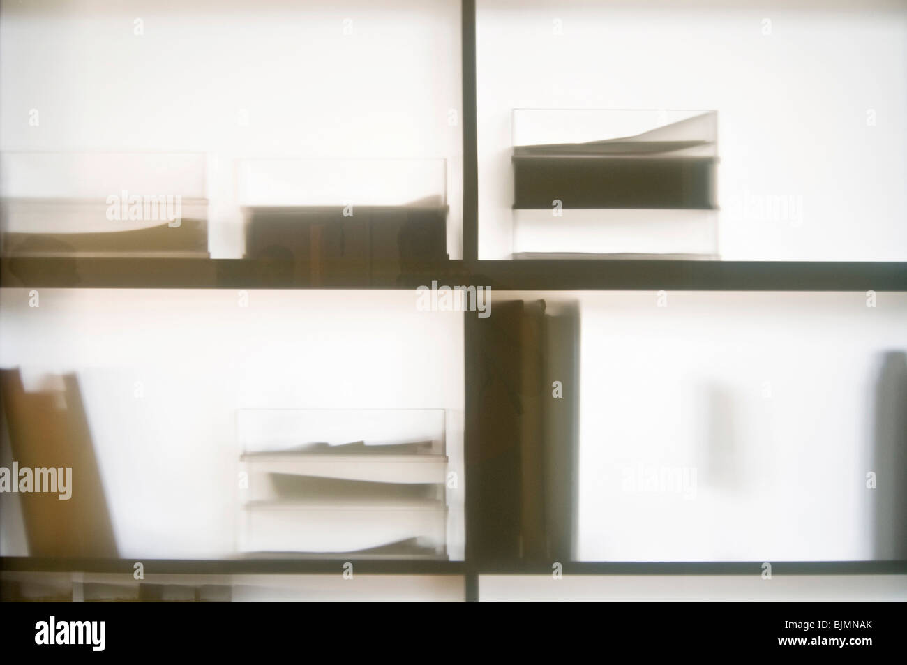 Shelves with trays and file folders behind a glass wall Stock Photo