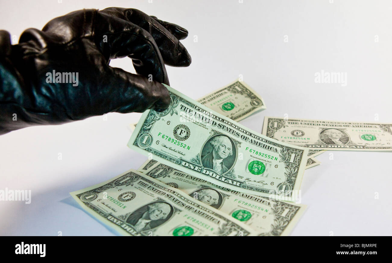 Gloved thief stealing U.S. Dollar Stock Photo