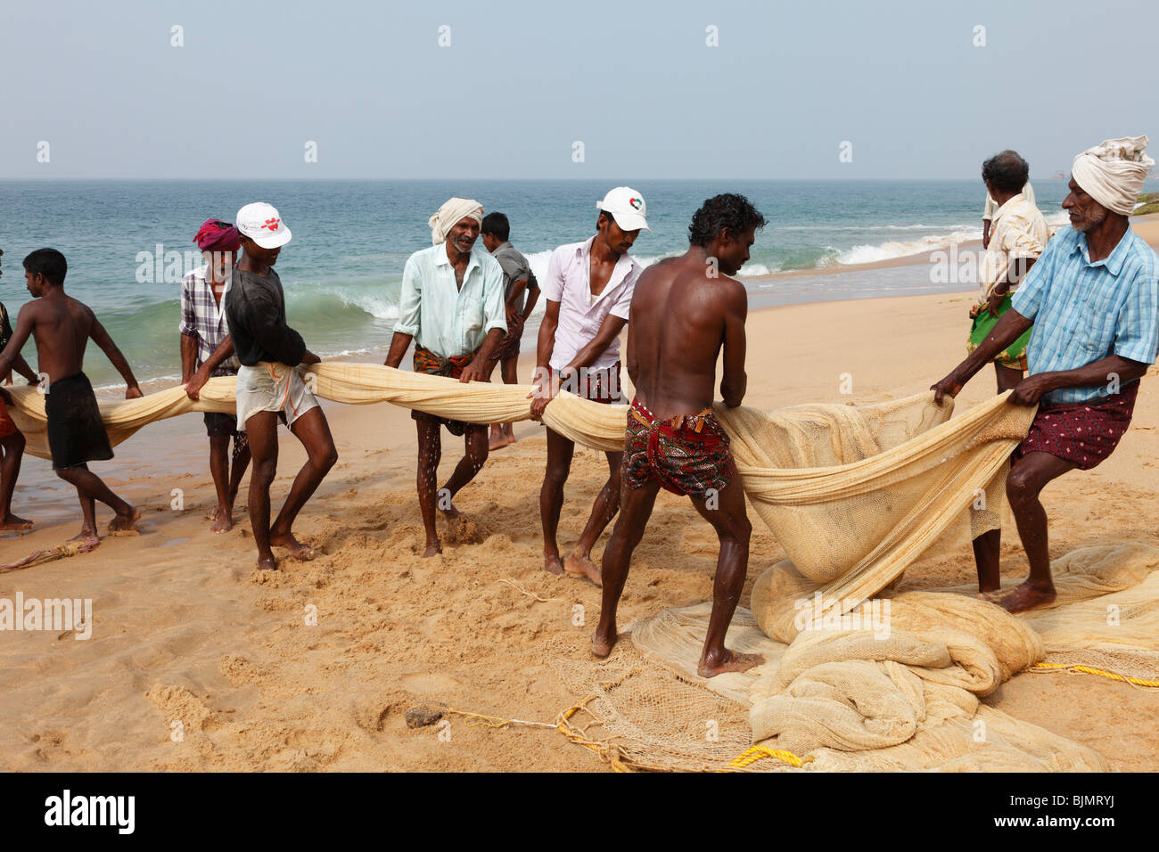 Fishermen pulling in a net, beach south of Kovalam, Malabar Coast, Malabar, Kerala, southern India, India, Asia Stock Photo
