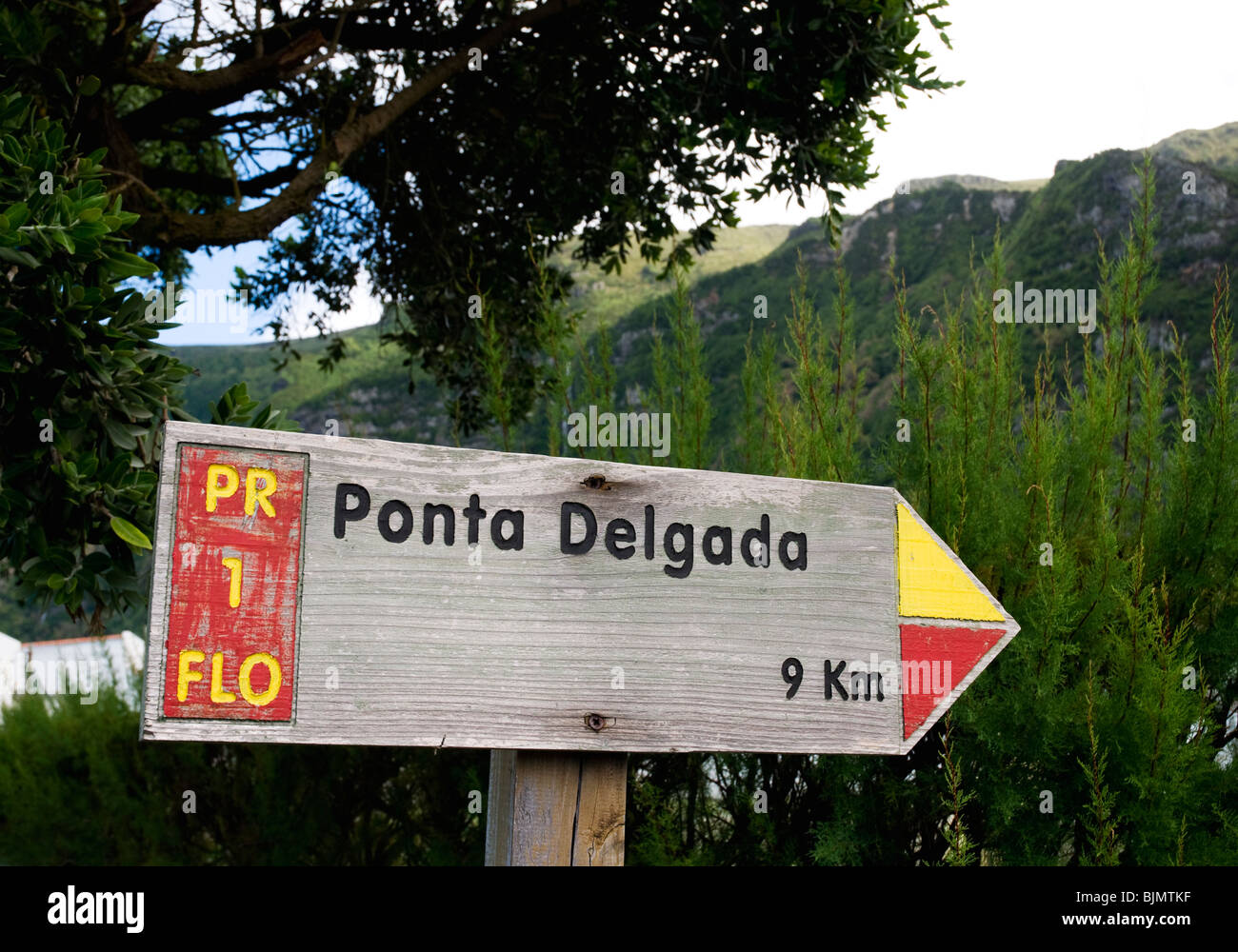 A way sign on Flores in the Azores indicating the distance to Ponta Delgada from Fajã Grande along the West walk hiking trail. Stock Photo