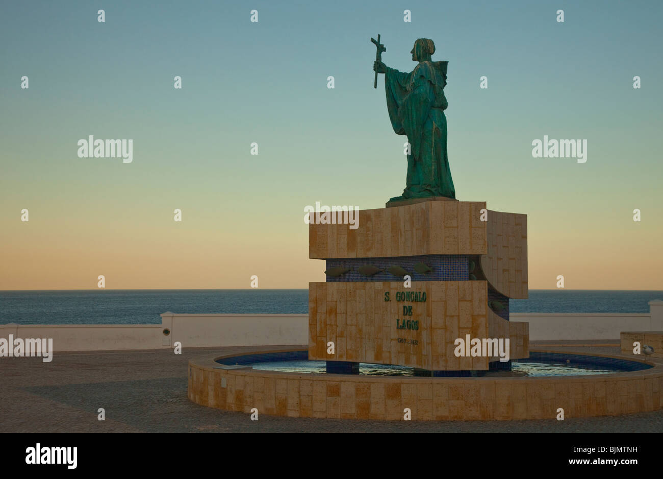 effigy of S Gonzalos de Lagos looking on the sea at sunrise in Portugal Stock Photo