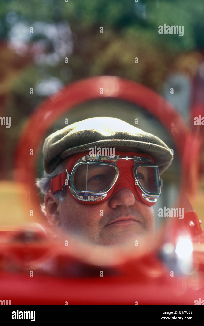 Reflection of driver in classic sports car rear view mirror Stock Photo Alamy