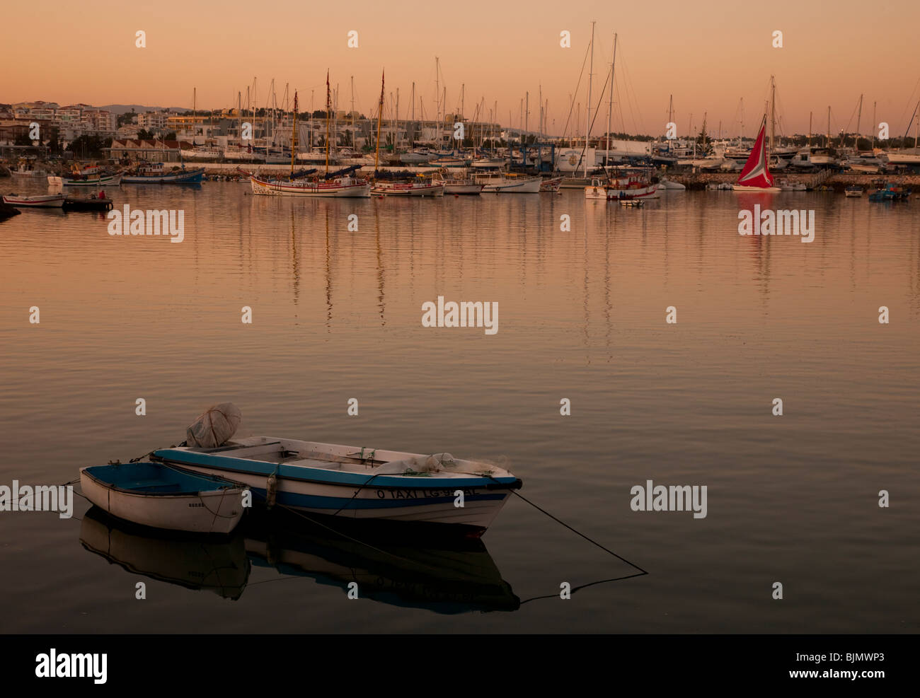 Fishing boat at sunset in the port of Lagos in Portugal Stock Photo
