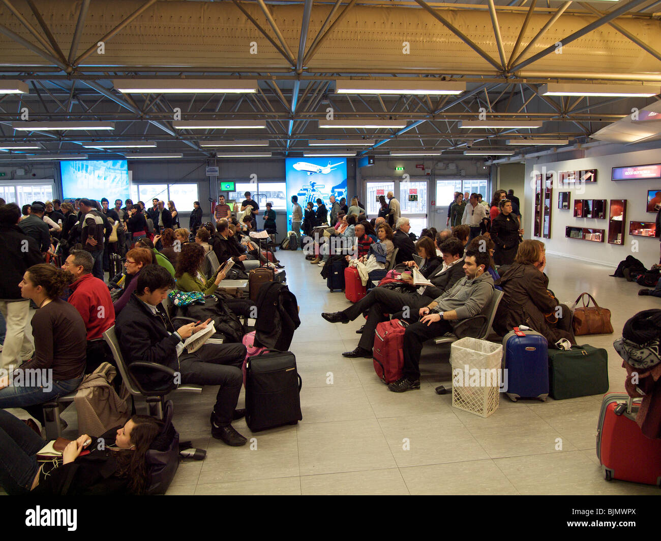 many people waiting in the departures area at Ciampino airport near Rome, Italy Stock Photo
