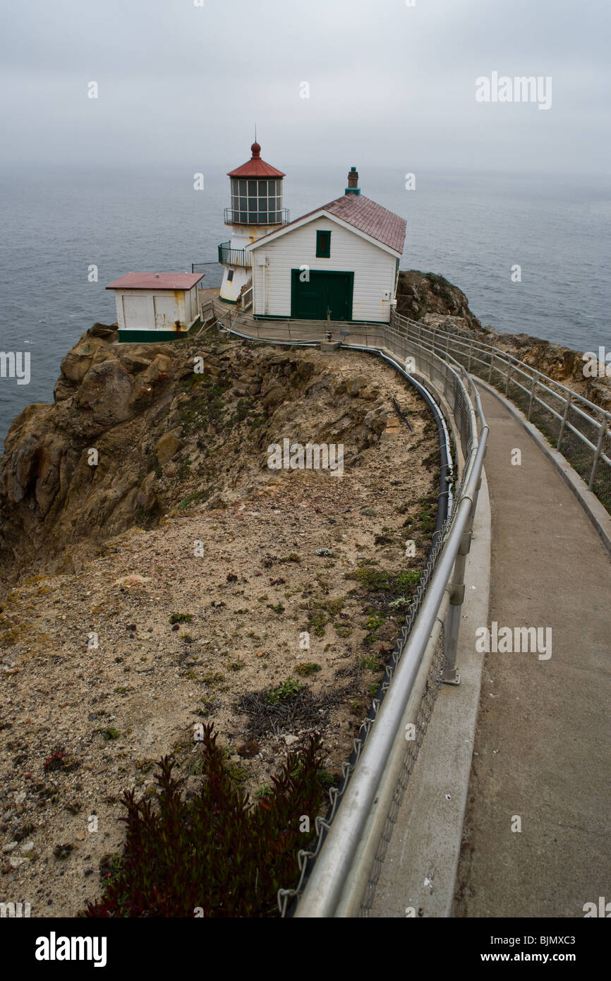 A long flight of stairs leads down the cliff to the lighthouse at Point