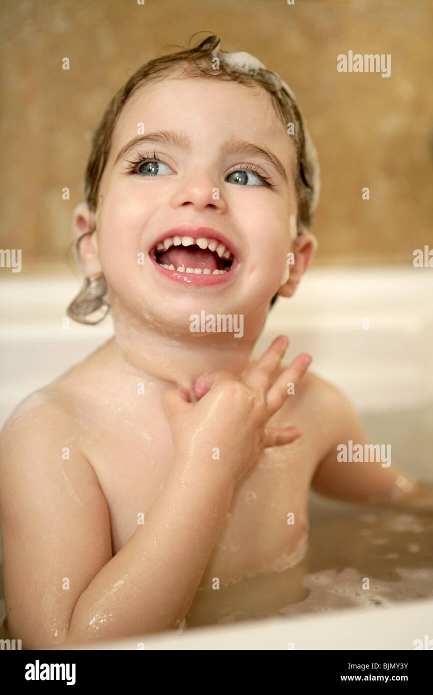baby little girl having bath on bathroom interior portrait Stock Photo