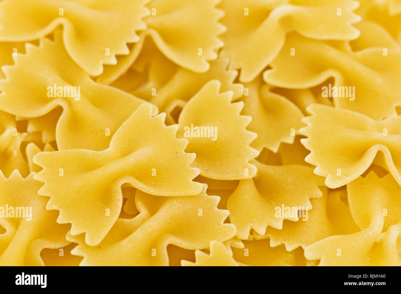 yellow unboiled macaroni close up Stock Photo