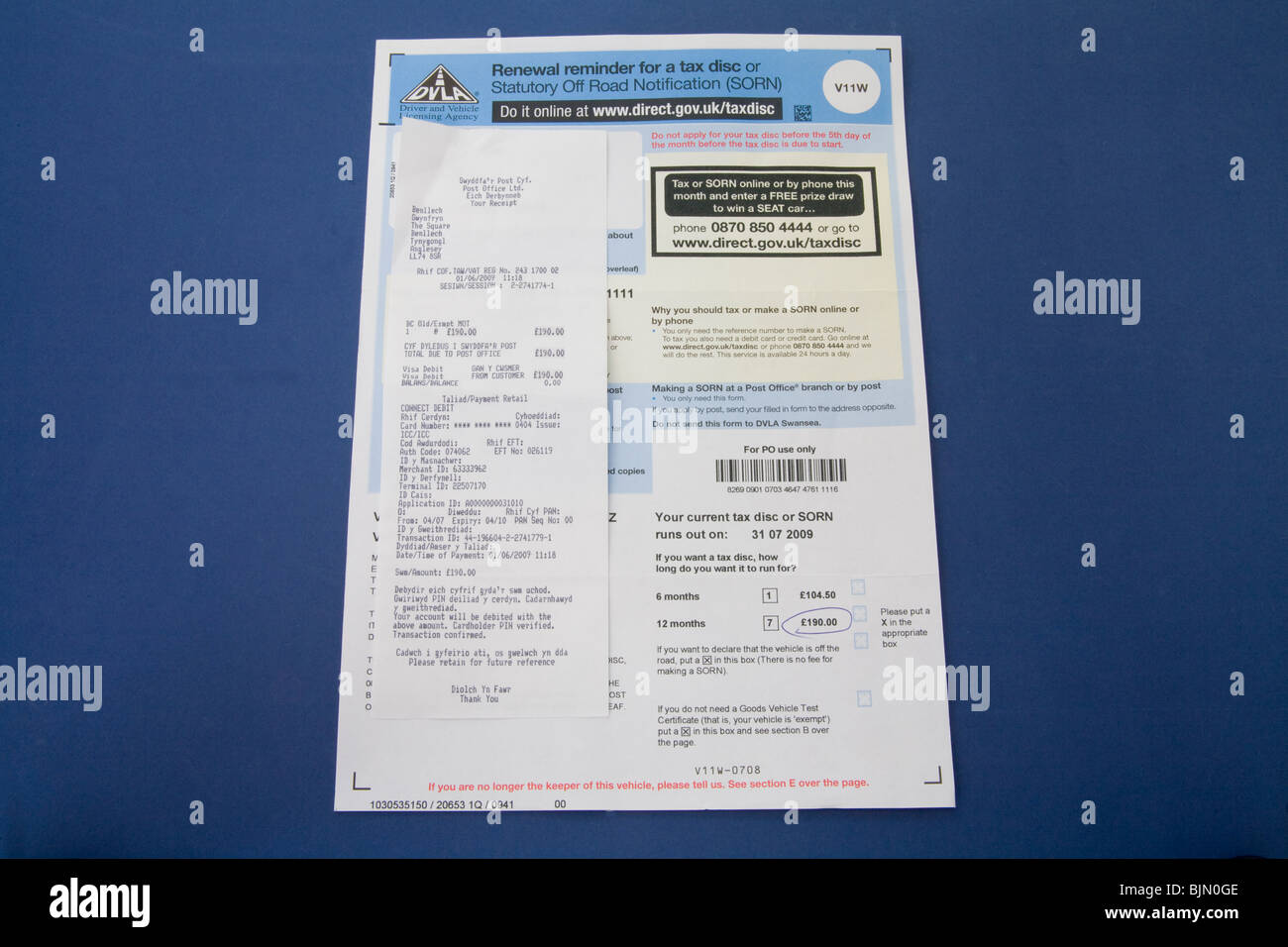 Close up Tax disc renewal notice from the DVLA and a receipt of payment