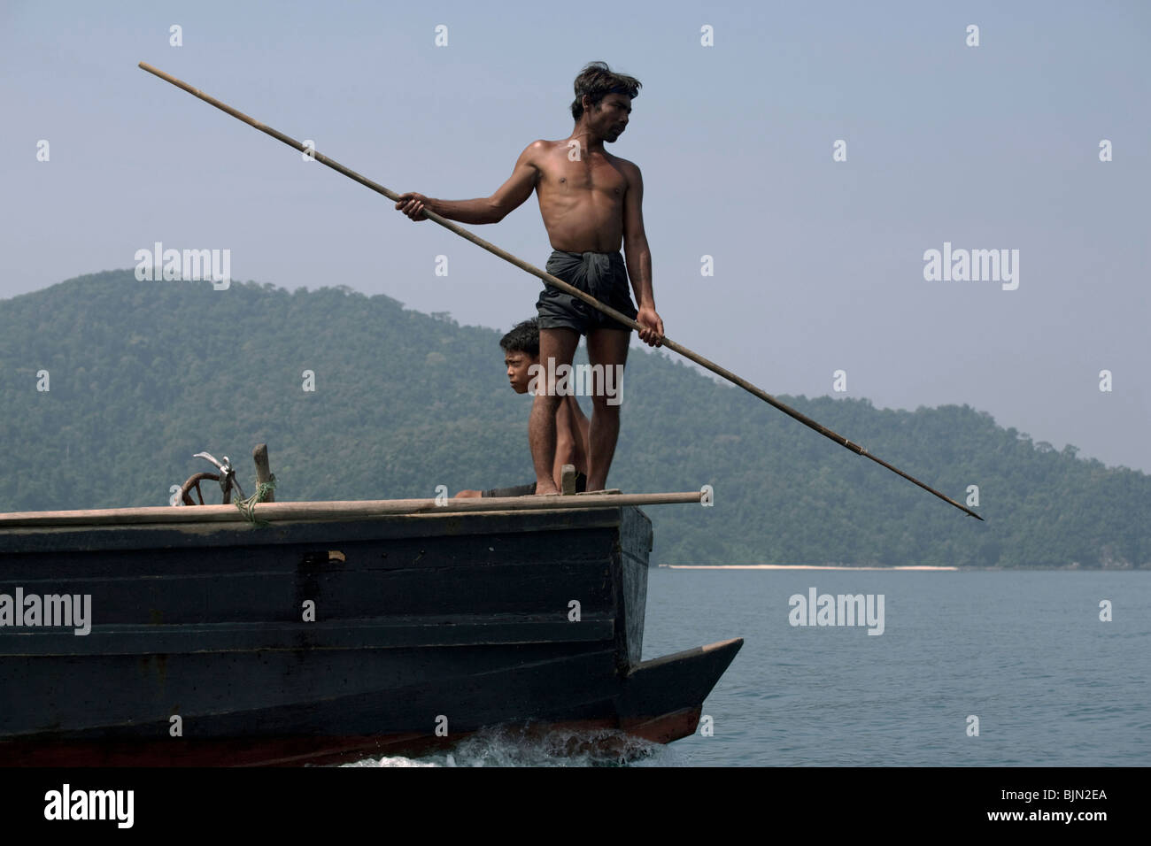 Myanmar sea-gypsies, the nomadic hunter-gatherers of South East Asia harpooning in the traditional way, from a boat prow. Stock Photo