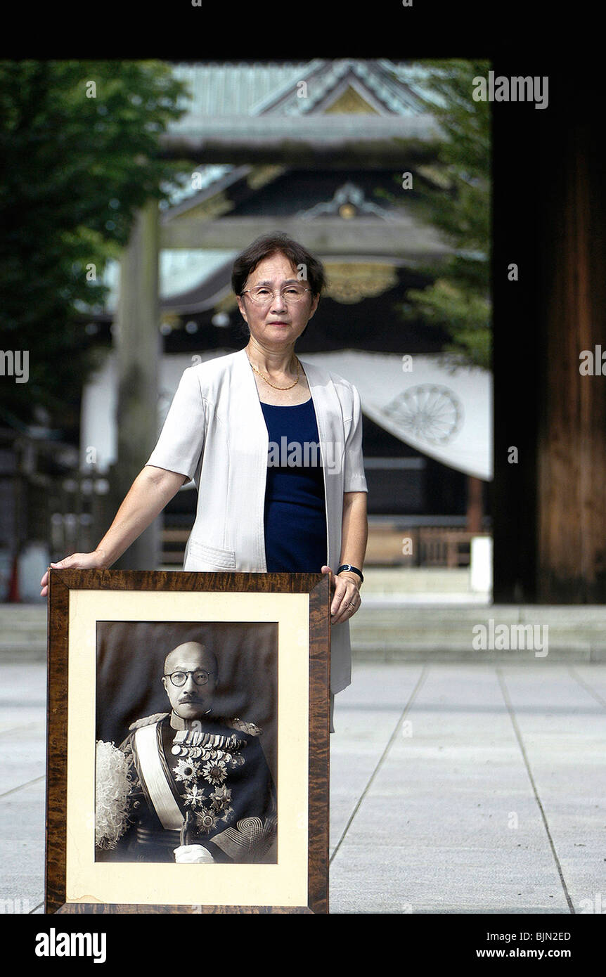 Yuko Tojo, granddaughter of Japan's wartime leader, Hideki Tojo, poses with a photo of her grandfather outside Yaskuni Shrine Stock Photo