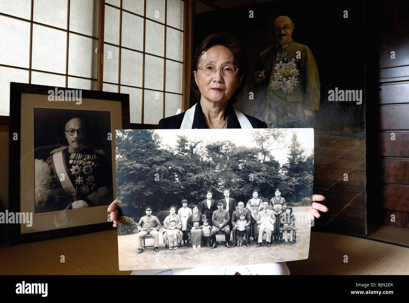 Yuko Tojo, granddaughter of Japan's wartime leader, General Hideki Tojo, poses with a family photo at her home in Tokyo Stock Photo