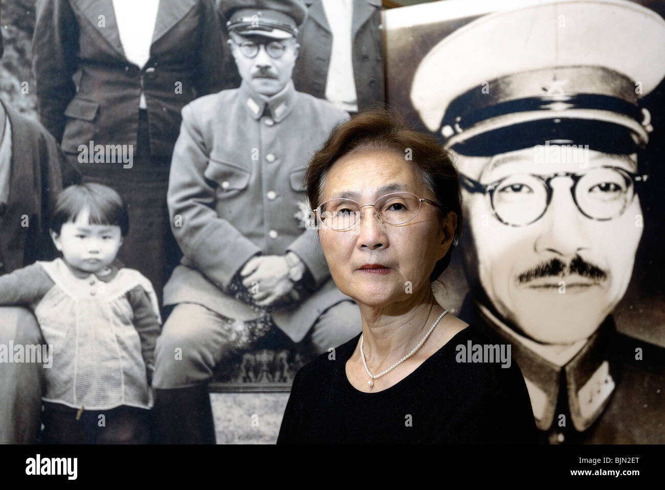 Yuko Tojo, granddaughter of Japan's wartime leader, General Hideki Tojo, poses in front of family photo in Tokyo Stock Photo