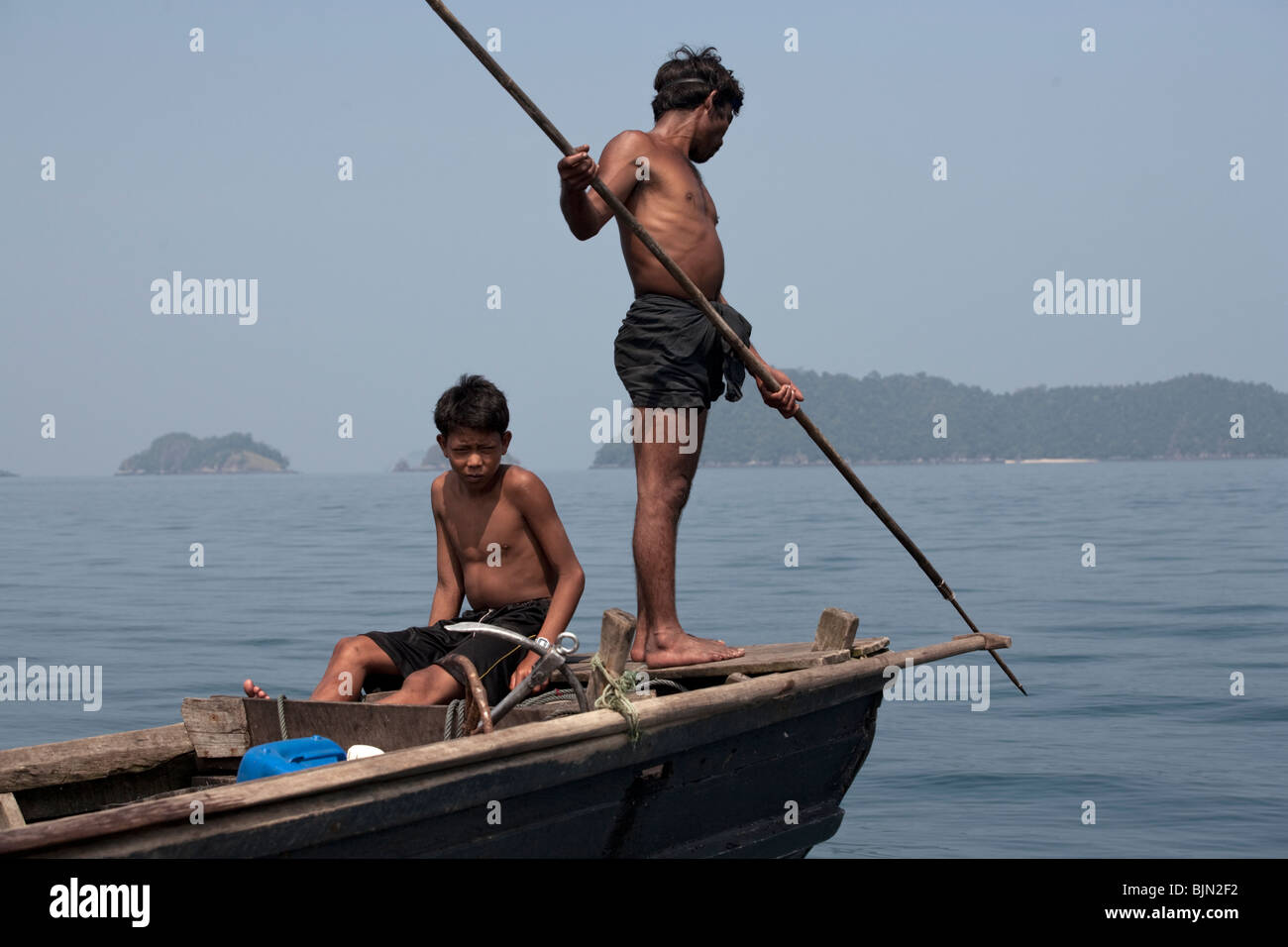 Myanmar sea-gypsies, the nomadic hunter-gatherers of South East Asia harpooning in the traditional way, from a boat prow. Stock Photo