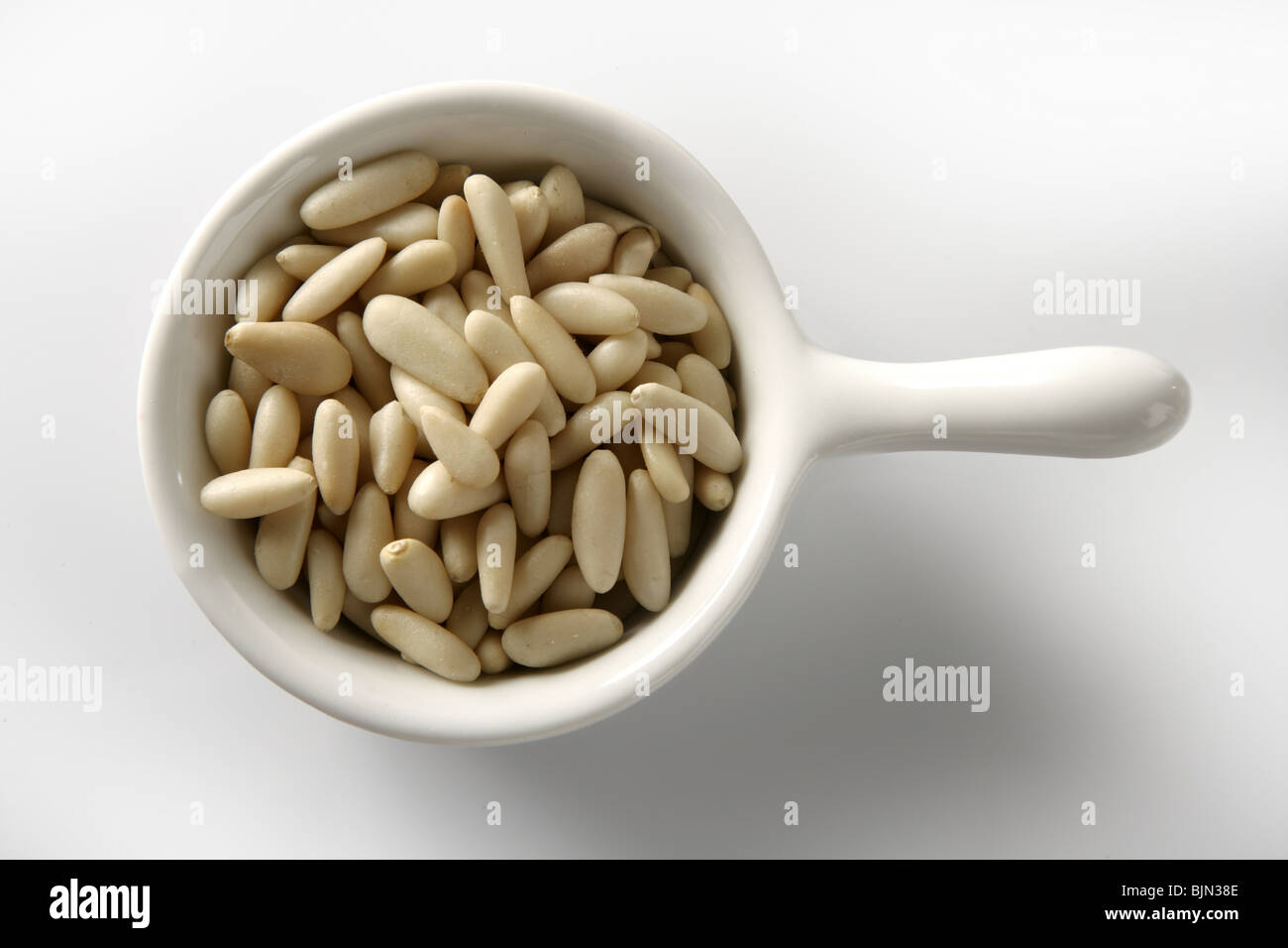 Abundant pine nuts in a closeup view, white background Stock Photo Alamy