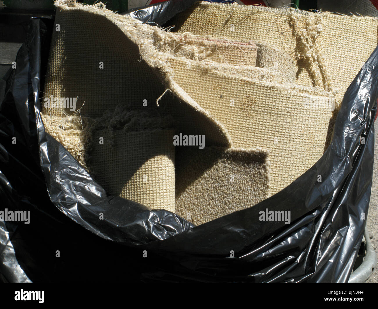 detail of old carpet in rubbish bin Stock Photo Alamy