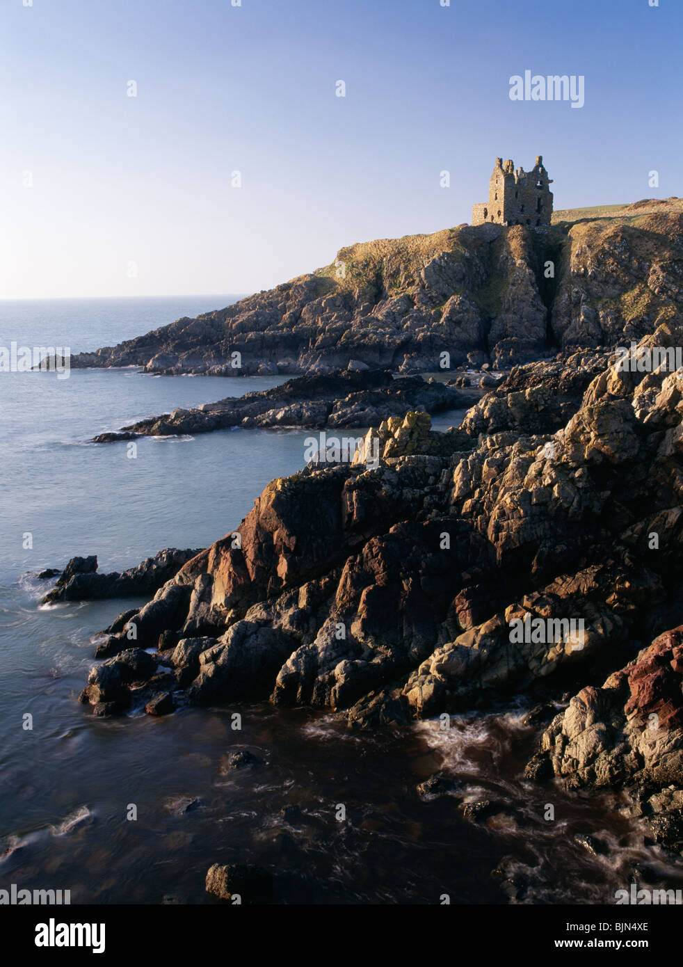 Dunskey Castle high on the cliffs above the sea looking up the North Channel to Ireland near Portpatrick Galloway Scotland UK Stock Photo