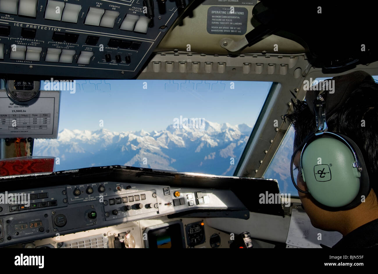 Flying past the Himalaya mountains Mount Everest in the distance Stock Photo