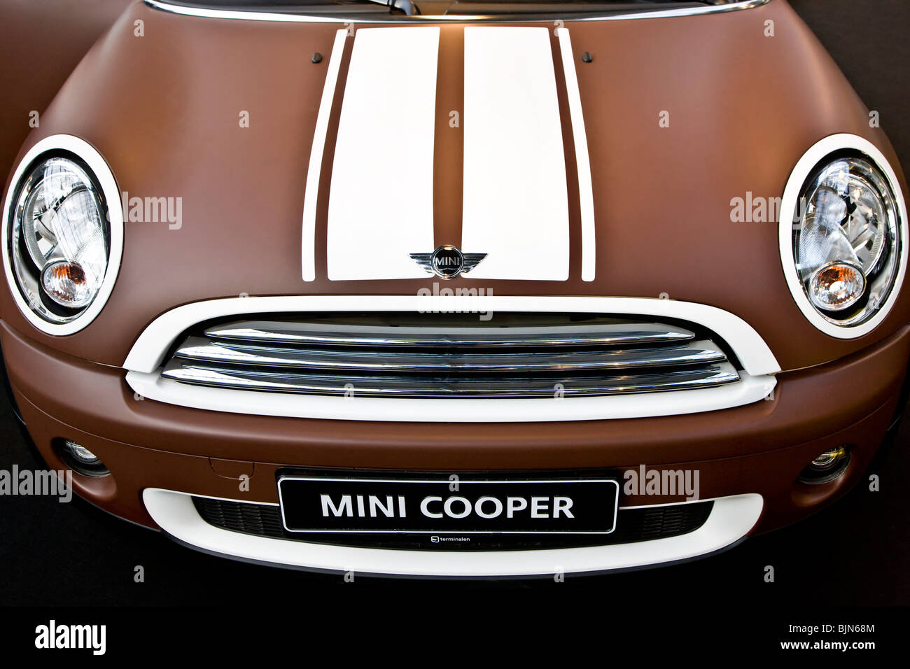 Front of dull brown and white painted Mini Cooper car Stock Photo