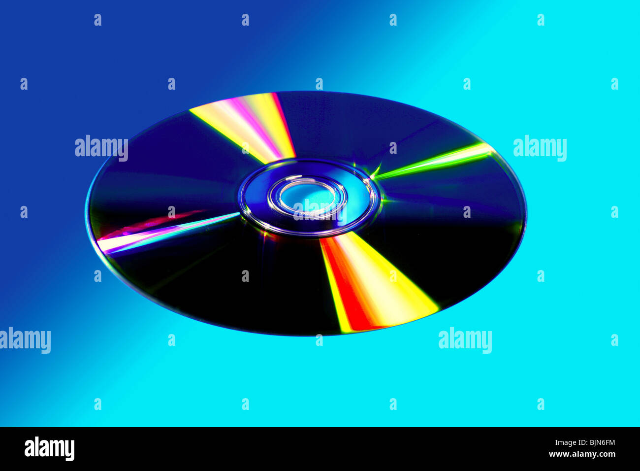 CD DVD disk with colorful reflexion over vivid blue background Stock Photo