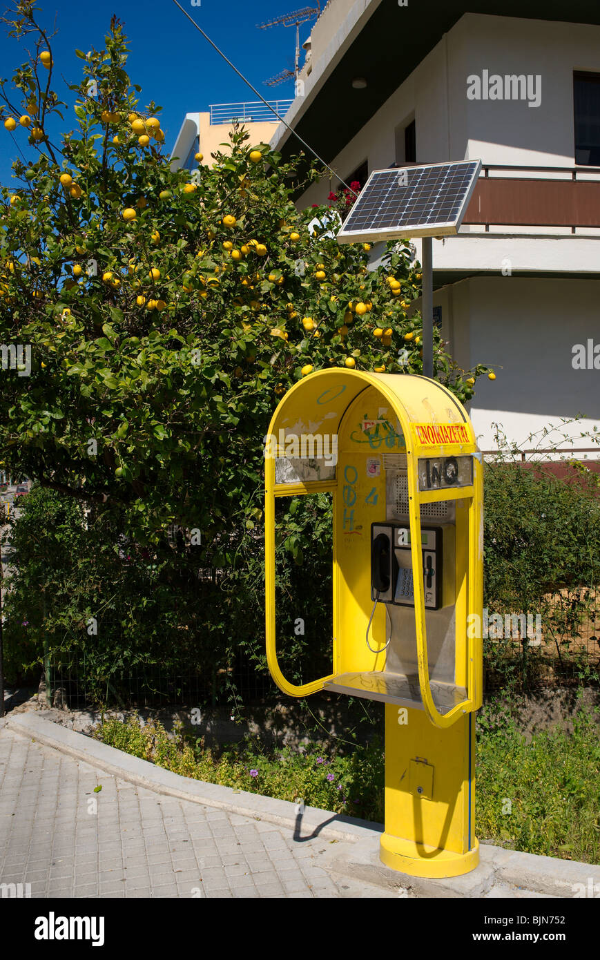 Greek public telephone box with solar panel Stock Photo
