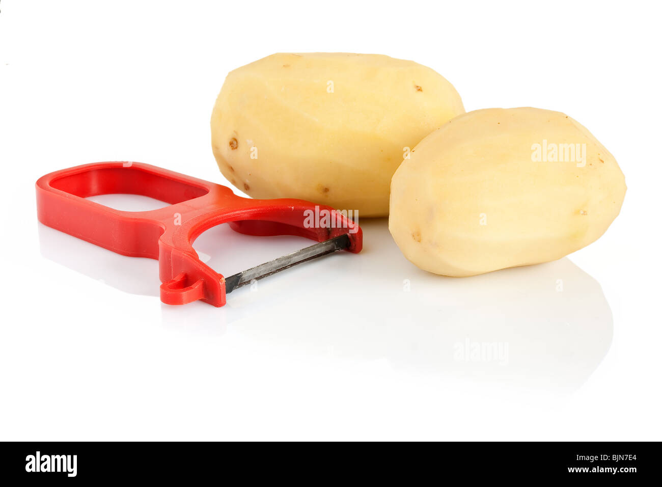 plastic potato pealer and two peeled potatoes isolated on white