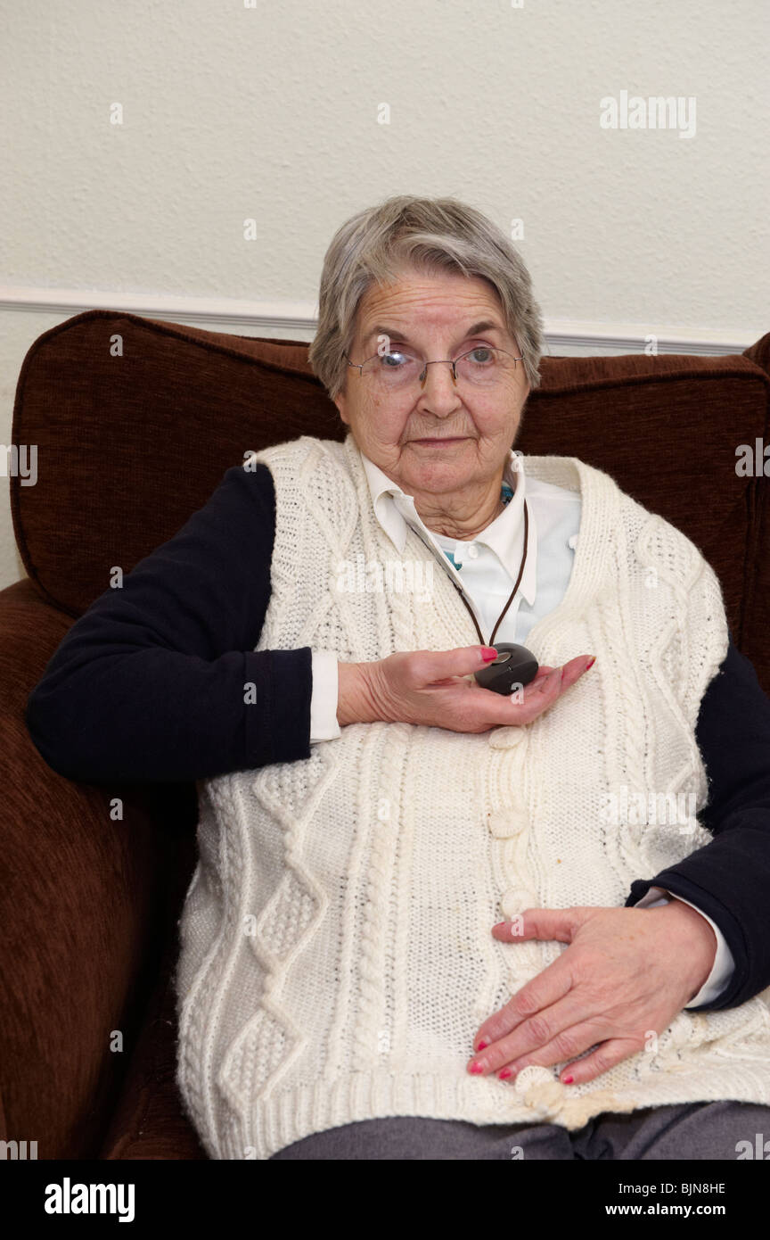 Elderly lady with emergency alarm around neck Stock Photo