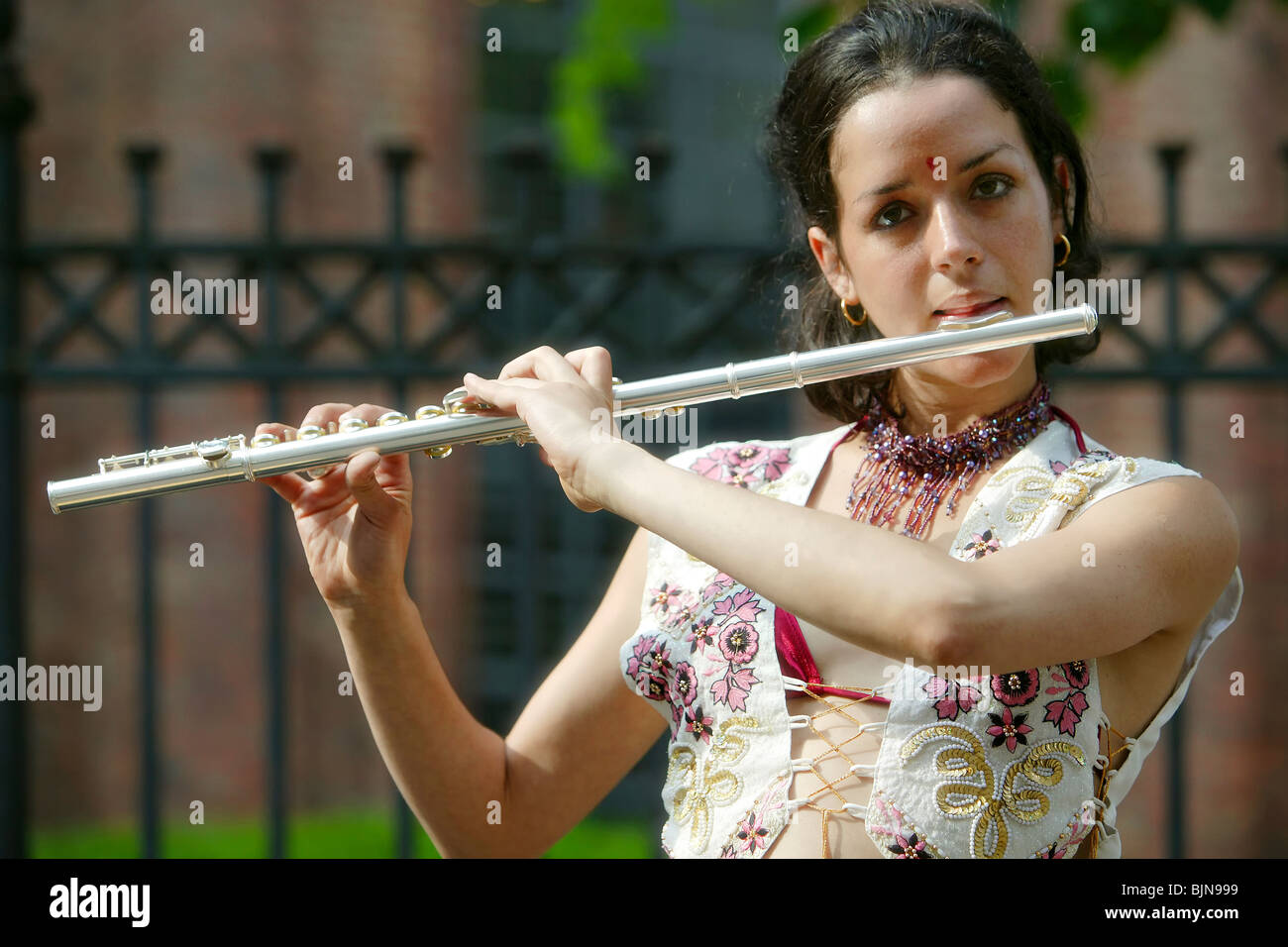Young female street musician playing transverse flute Stock Photo Alamy