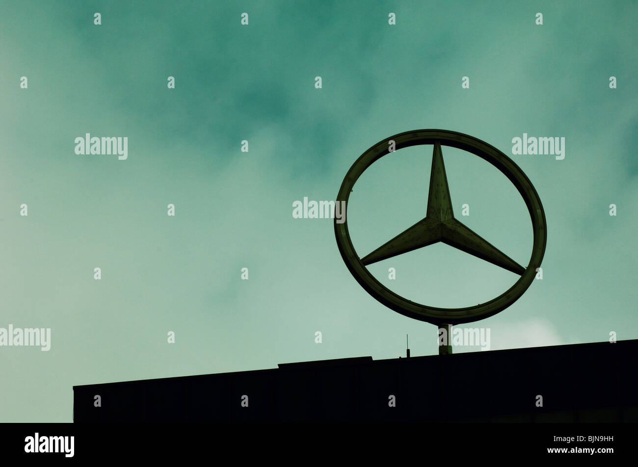 The Mercedes Benz logo on top of building Berlin Germany Stock Photo