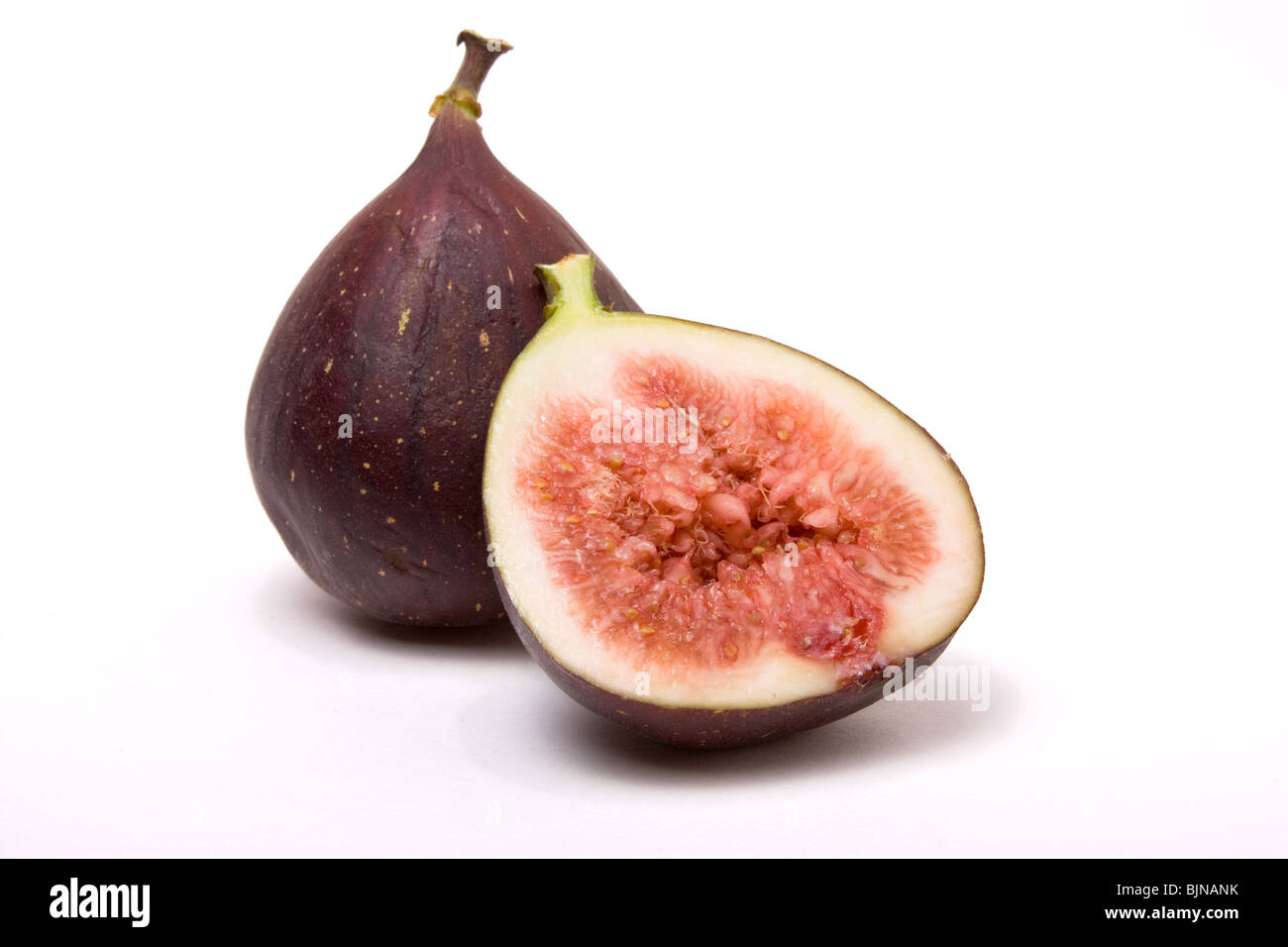 Figs one halved isolated against white background. Stock Photo