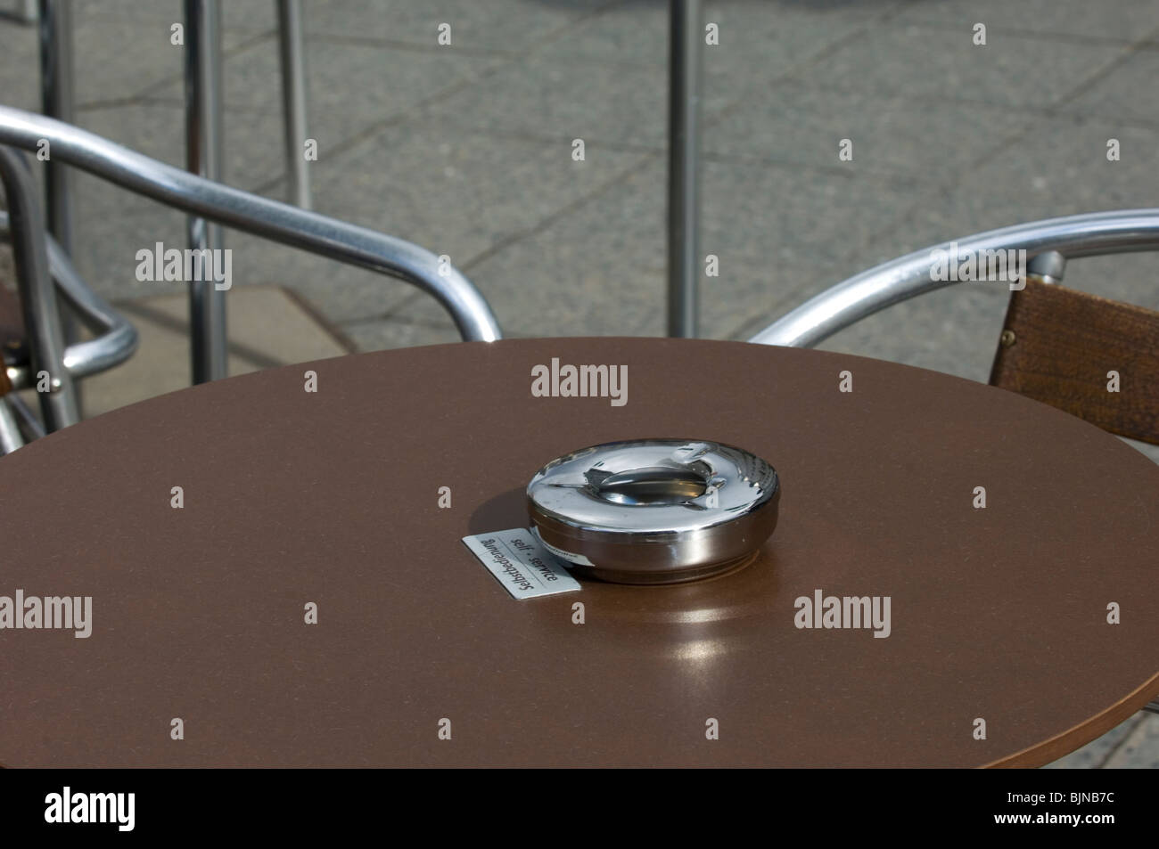 Ashtray on a table outside a coffee shop Berlin city center Germany Europe Stock Photo