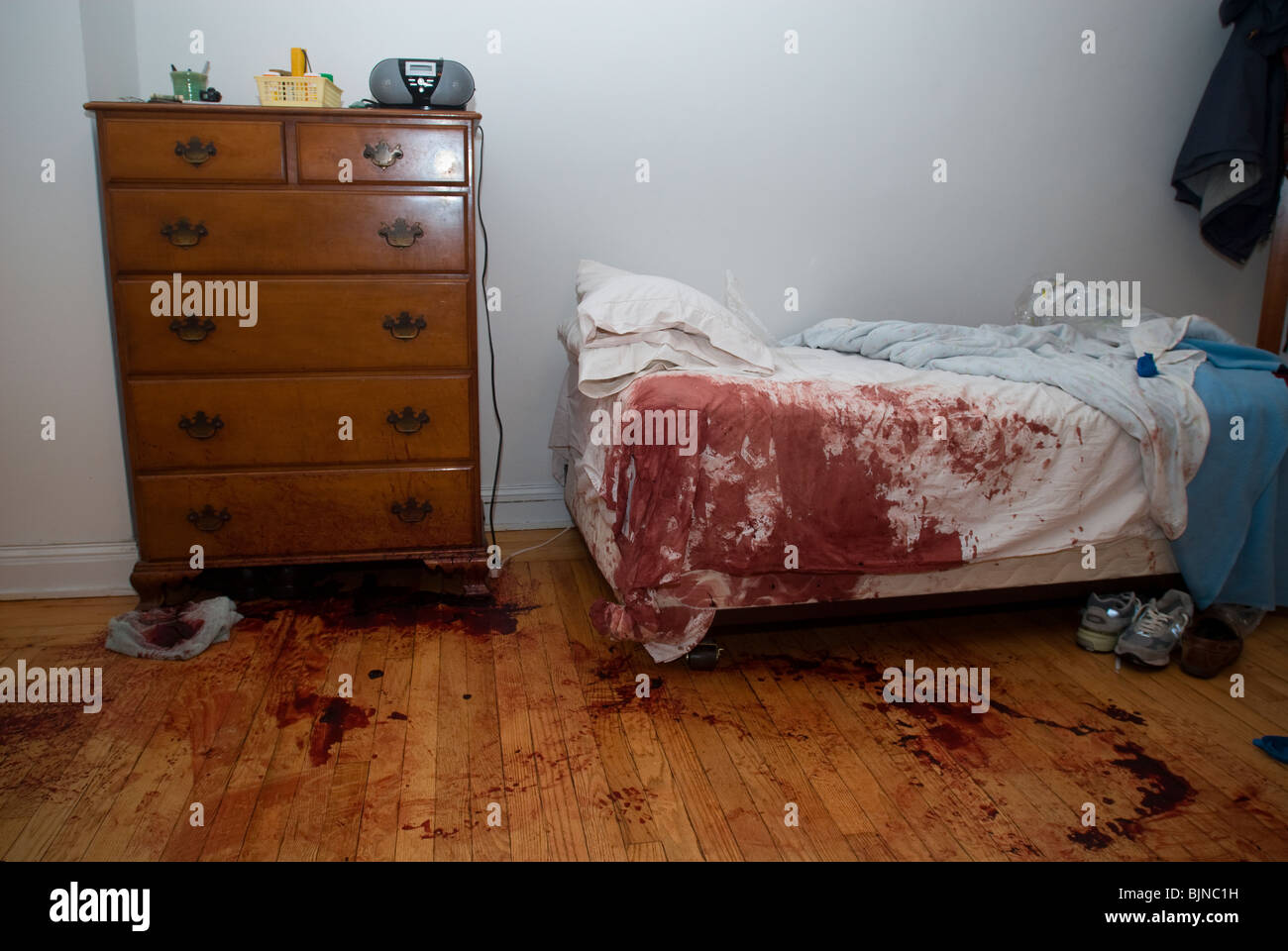 Blood stained bed and floor are seen in an apartment in New York after a horrific accident Stock Photo