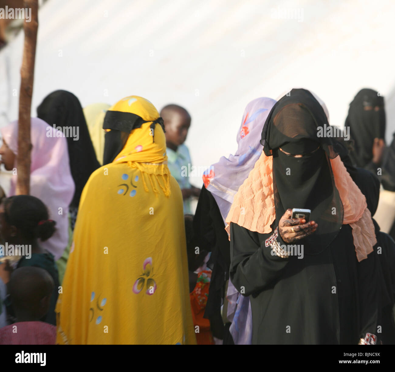 A Swahili woman checks her mobile phone during the traditional Maulidi festivities Stock Photo