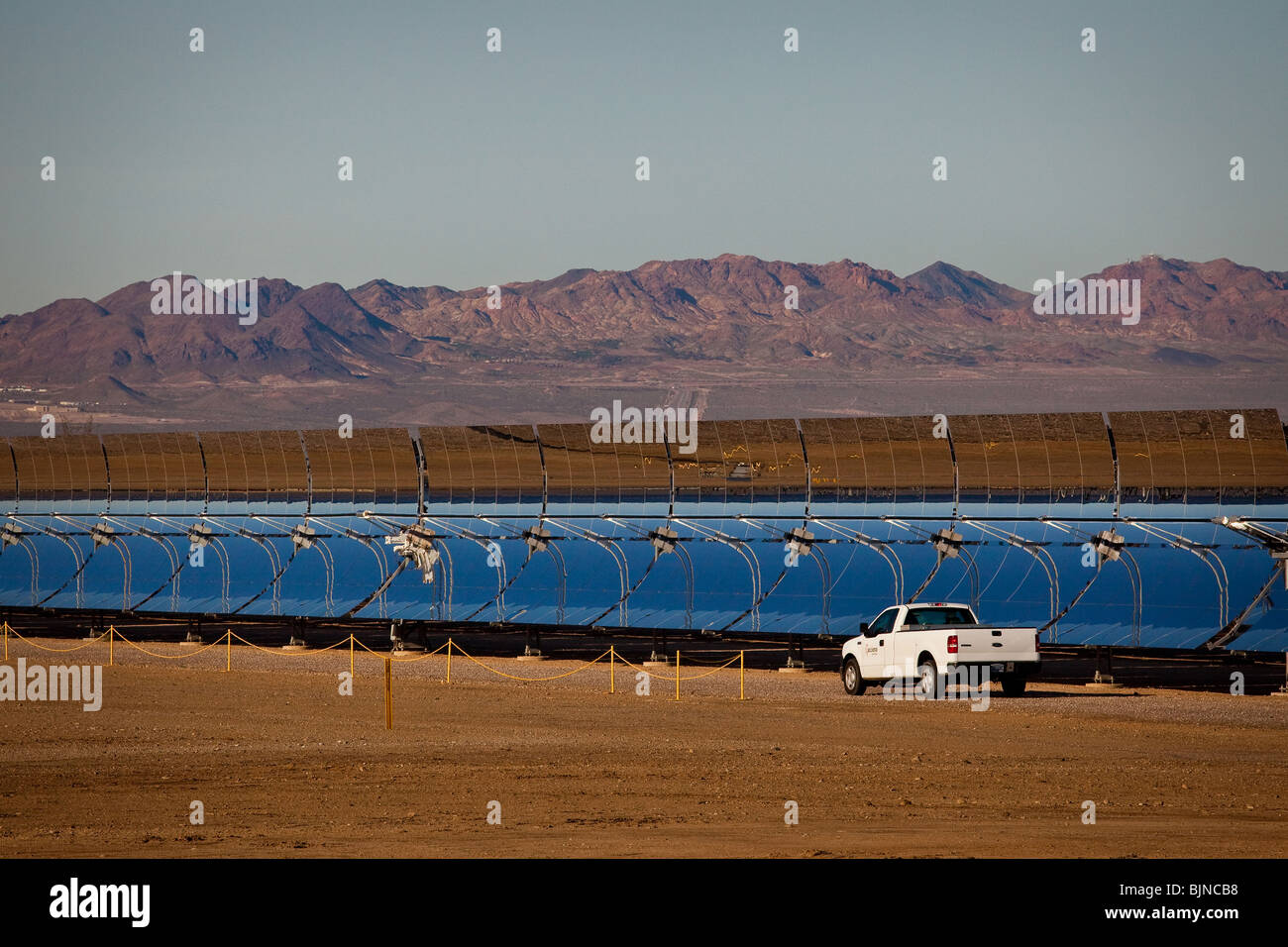 A truck drives past one of the massive parabolic mirrors at Nevada Solar One power plant in Boulder City, Nevada. Stock Photo