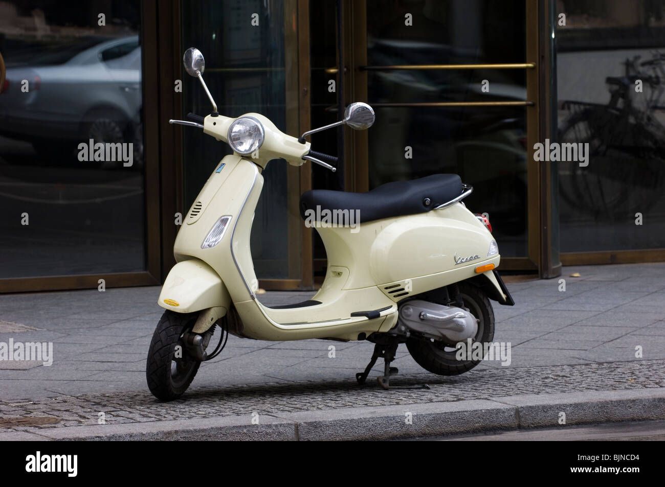 Vespa scooter parked on the sidewalk on Friedrichstrasse Berlin Germany Stock Photo