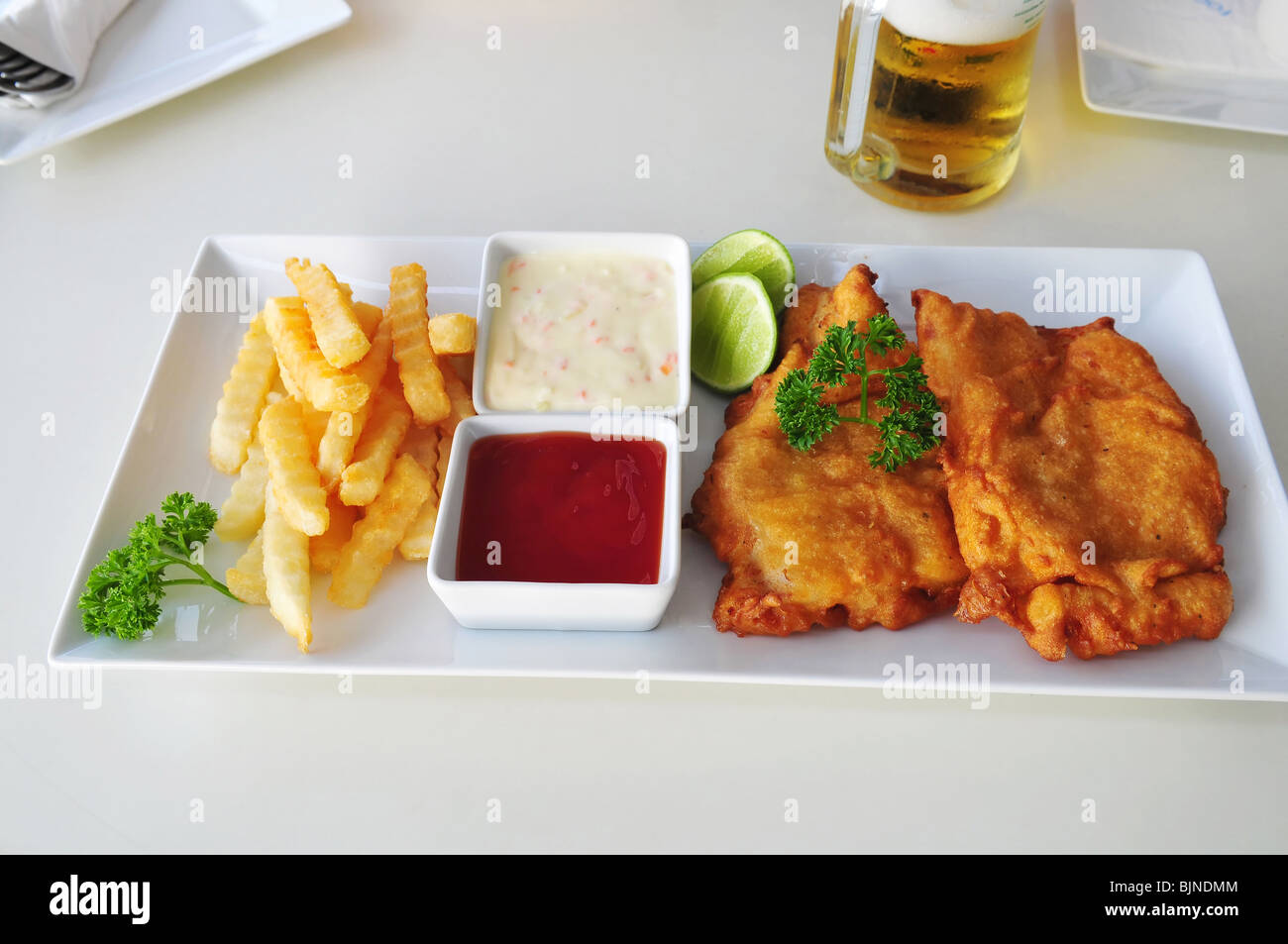 fish and chips on table at street café Stock Photo